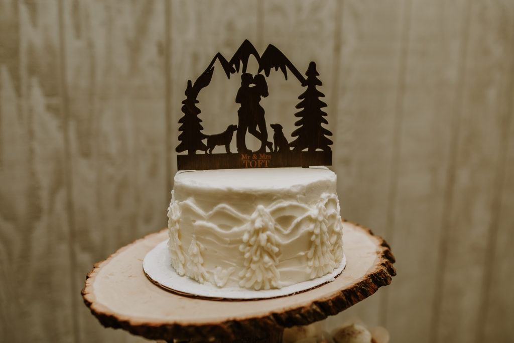 bride and groom cake with dog topper