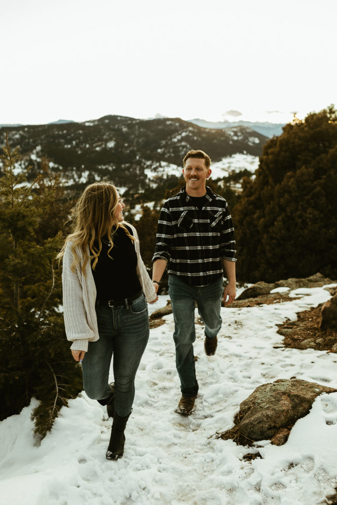 couple walking together in front of mountains